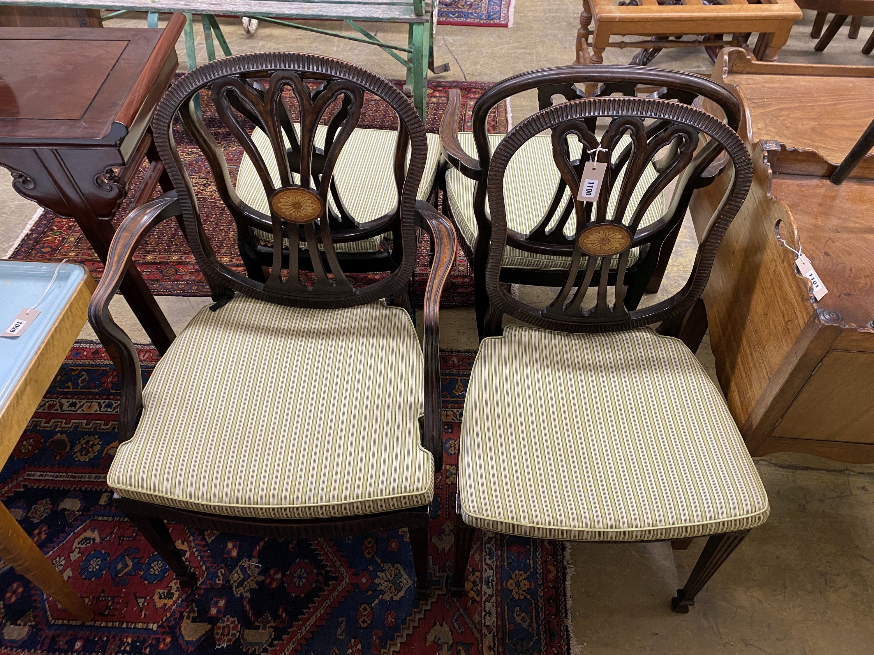 A set of four Edwardian George III style inlaid mahogany dining chairs with arms